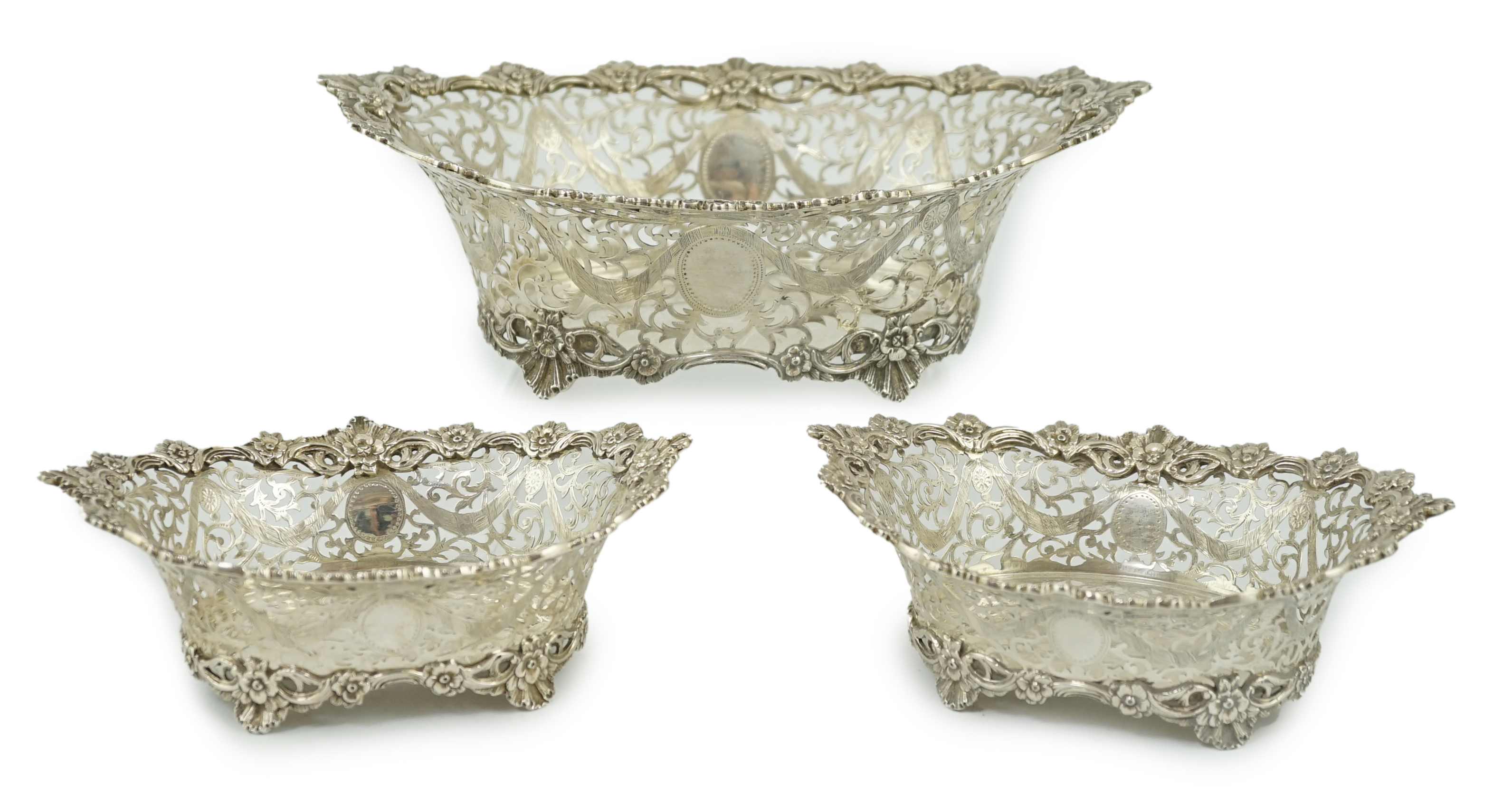 A graduated suite of three George V pierced silver oval bowls, by Charles Stuart Harris & Sons